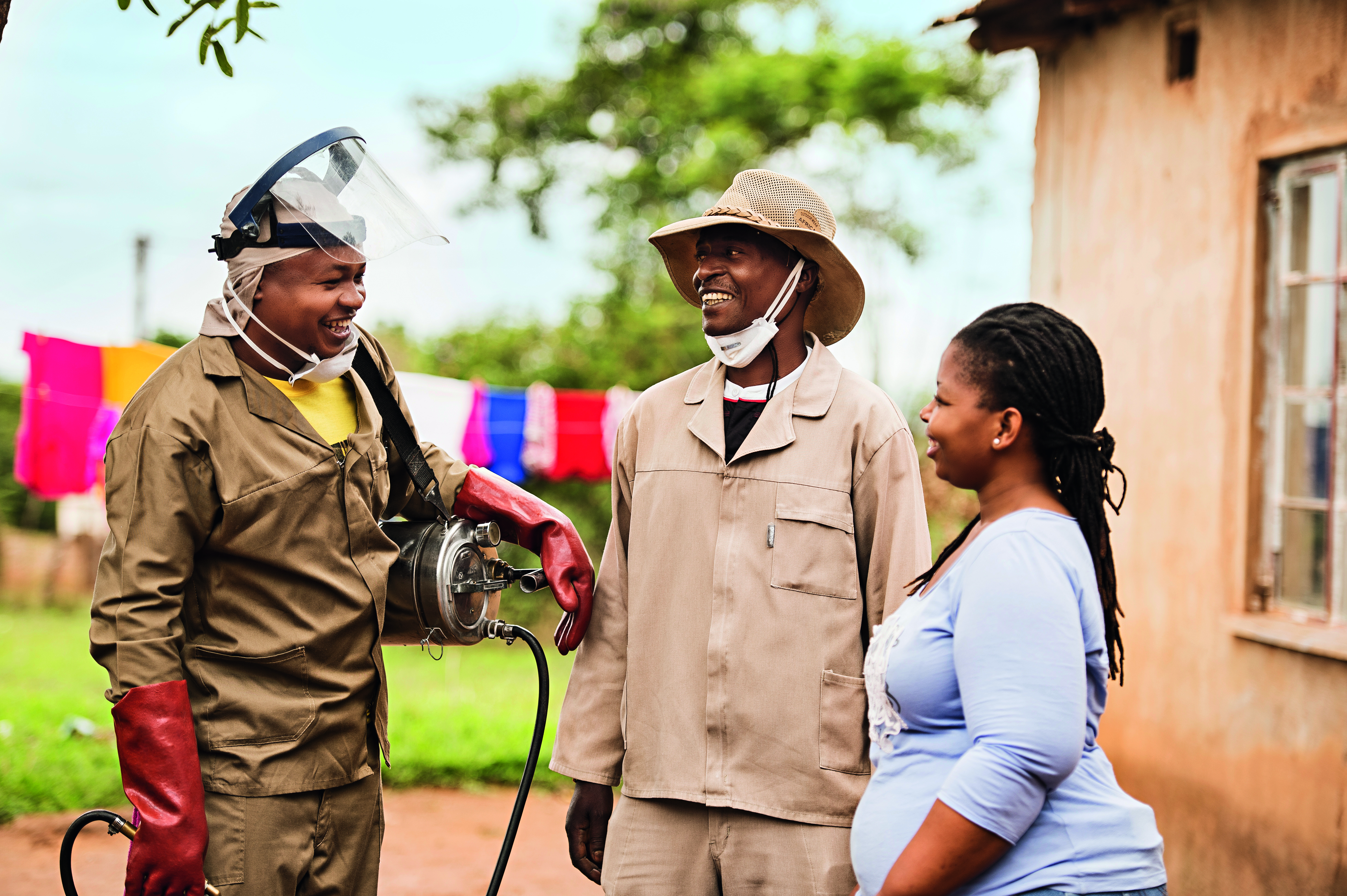three people smiling and talking