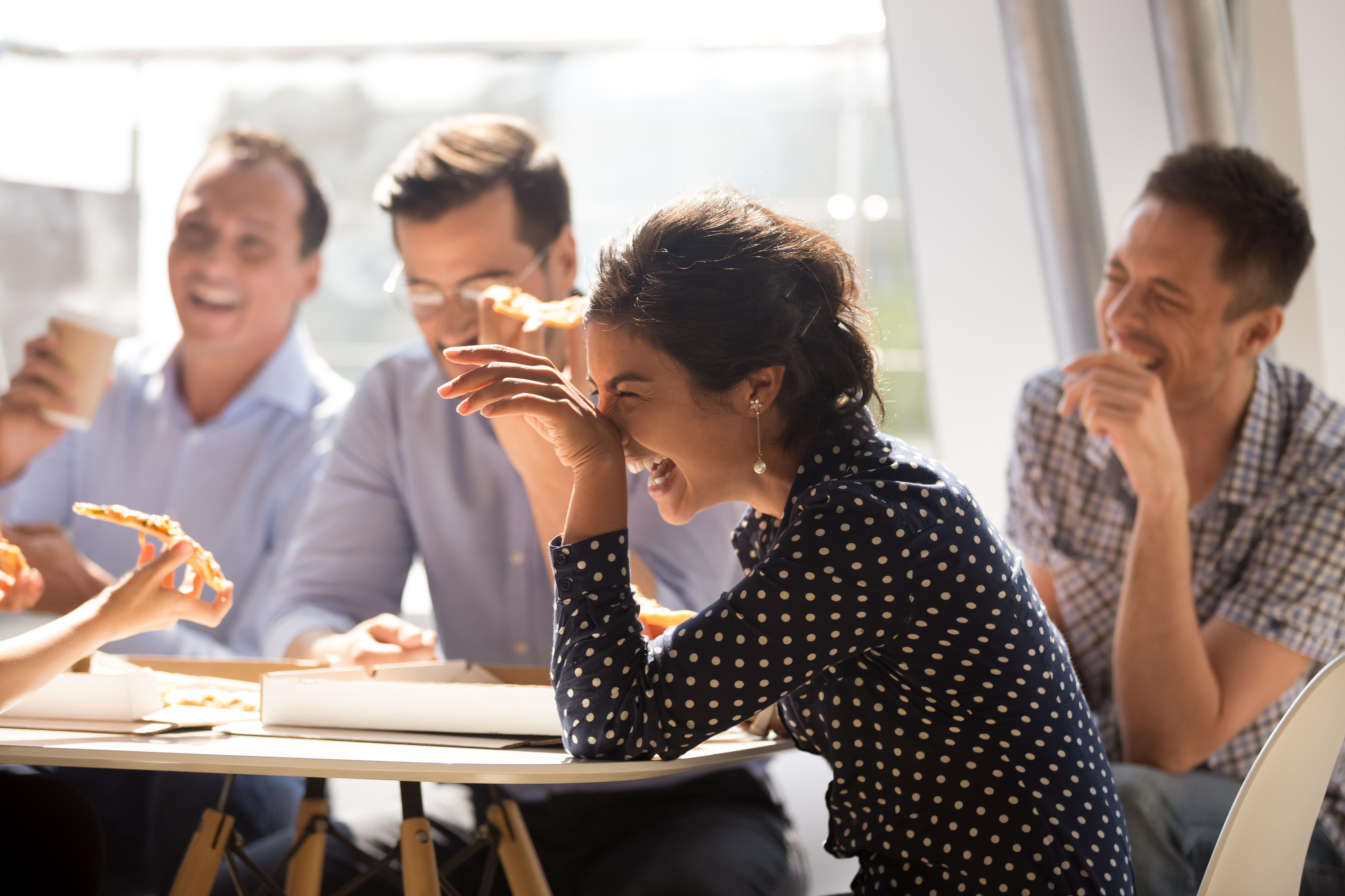 people laughing sitting at table