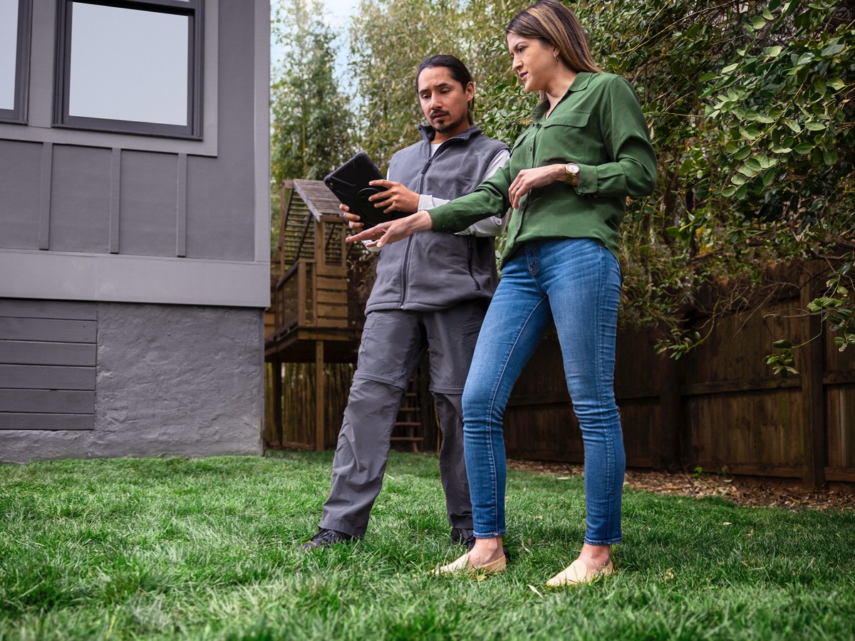couple of people talking on lawn
